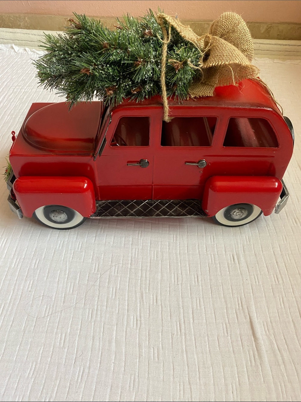 A Red Vintage Christmas Truck Decor With a Pine Tree on top